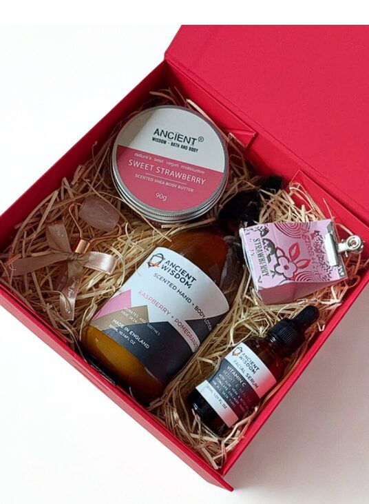 Cosmetic gift set with lip balm, body butter, lotion, serum and rose quartz roller